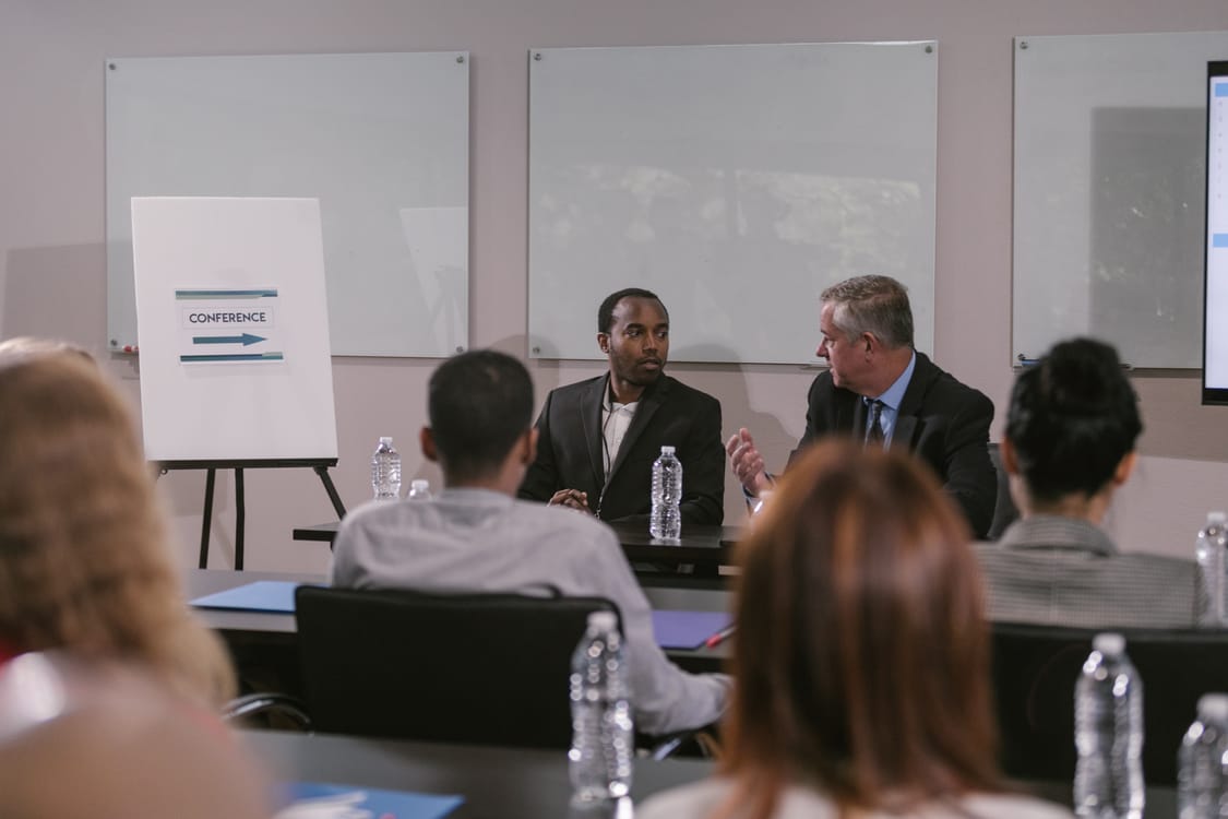 A conference panel discussion. Registration data helps organisers plan seating, catering, and session capacity before the day. Photo by RDNE Stock project.