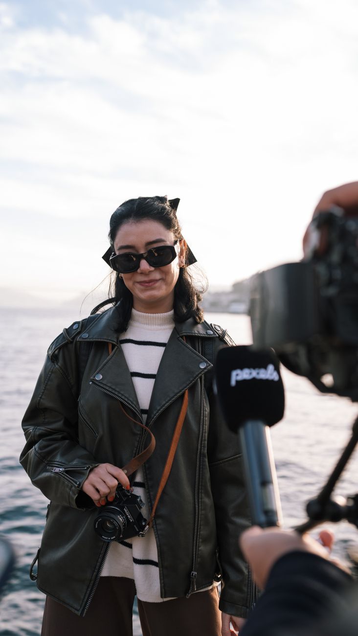 A street interview being filmed with a handheld microphone and camera.